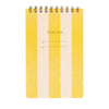 Yellow and beige task pad with spiral binding on a white background