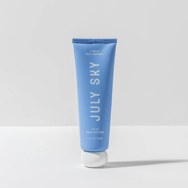 Blue tube of July Sky sunscreen on a white background