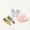 Set of three colorful cat-shaped hair clips on a white background