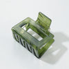 Green hair clip on a white background