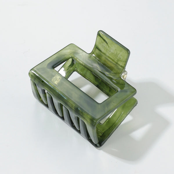 Green hair clip on a white background