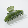 Green hair clip on a white background