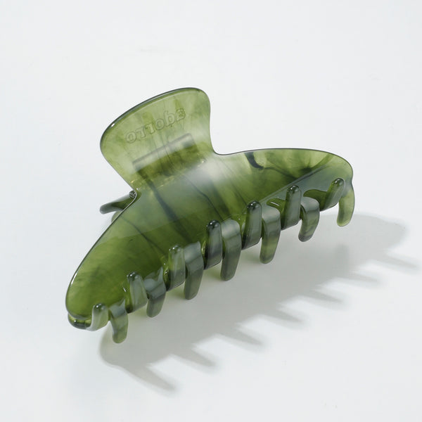 Green hair clip on a white background