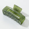 Green hair clip on a white background