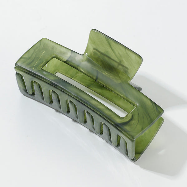 Green hair clip on a white background
