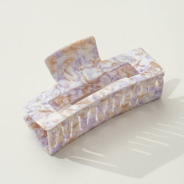 Large rectangular purple and gold swirled hair claw on white background.
