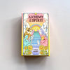 A hardcover box for 'Alchemy of the Spirit' oracle deck by Cristina Gonzalez against a neutral background. 