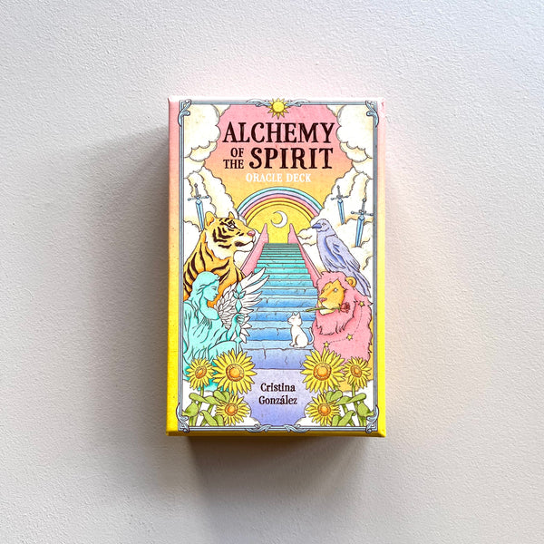 A hardcover box for 'Alchemy of the Spirit' oracle deck by Cristina Gonzalez against a neutral background. 