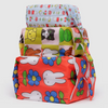 A stack of three expandable nylon packing cubes featuring colorful designs with the Miffy character.