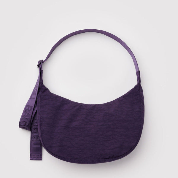 A dark purple nylon half moon crossbody back against a white background.
