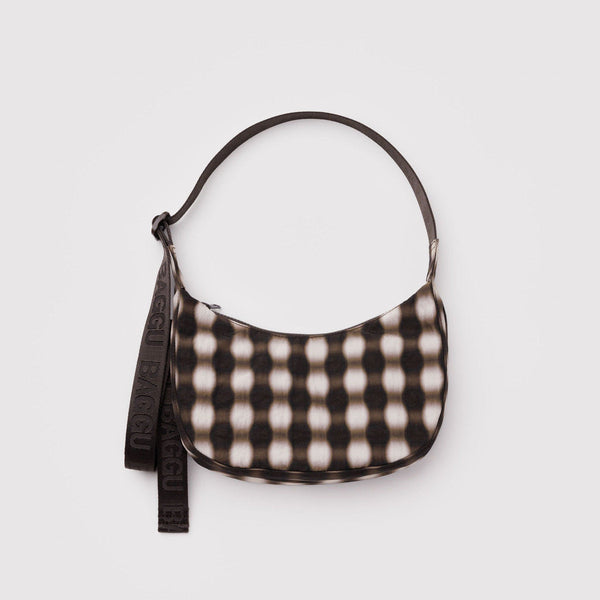 A small nylon crescent crossbody bag with a blurry brown gingham pattern against a white background.