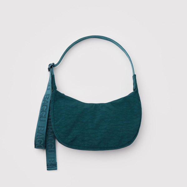 A small dark teal nylon crescent crossbody bag against a white background.