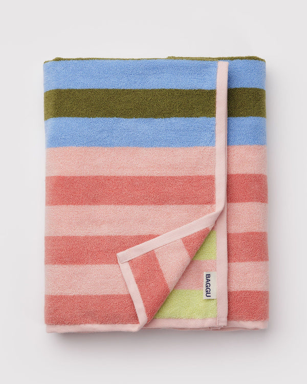 Folded striped towel with multicolor pattern on a light gray background
