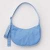 Blue nylon crescent-shaped bag on a light gray background