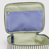 The interior of a sage green and white striped nylon cosmetic case. The interior is solid green with a blue mesh zipper pocket. 