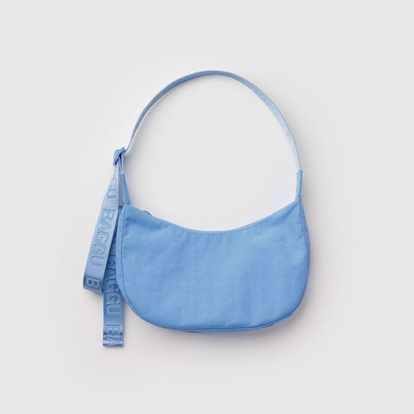 Light blue nylon crescent shaped handbag on a light grey background.