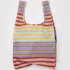 A nylon shopping bag in a gradient muted multicolor stripe on a white backdrop.