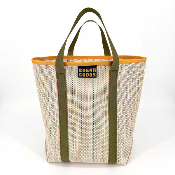 Woven tote bag with green handles and orange trim on a white background