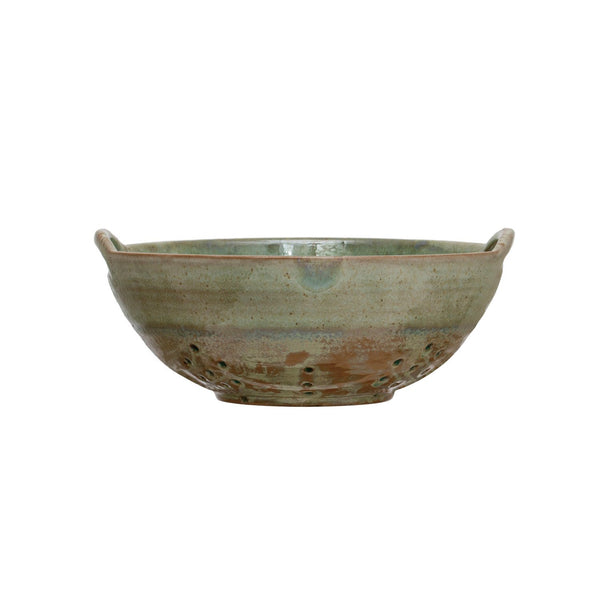 Green ceramic berry bowl with brown accents on a white background