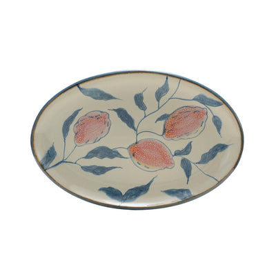 Ceramic platter with blue and orange lemon design on a white background