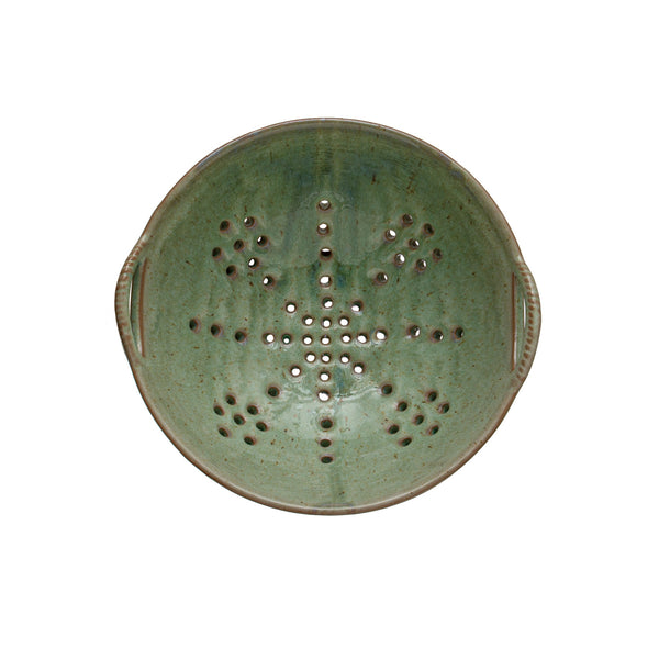Green ceramic strainer berry bowl on a white background