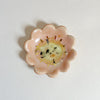 Peach pink floral ceramic dish with a gold accents on a white background