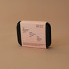 Rectangular container with a label on a beige background