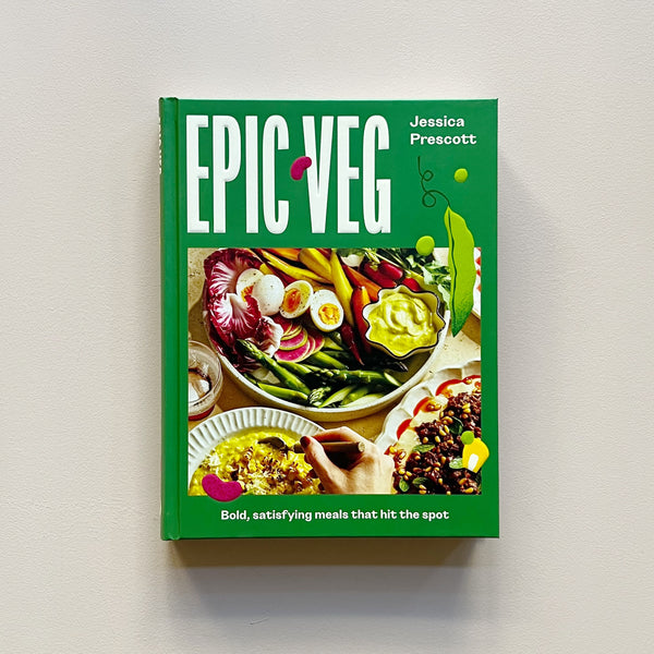 A bright green cookbook called 'Epic Veg' by Jessica Prescott with a colorful photo of a salad, soup, and entree. The book sits against a neutral backdrop.
