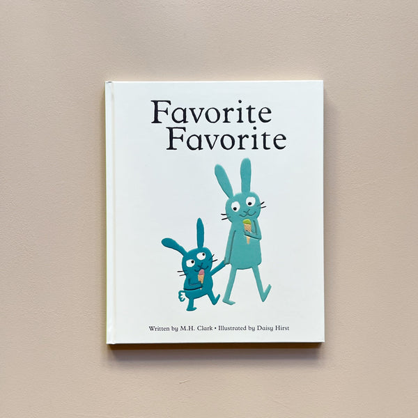 An illustrated children's book called 'Favorite Favorite' with a white cover and an adult and kid bunny pair eating ice creams, rendered in shades of teal. The book sits against a neutral backdrop.