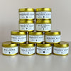 Stack of candles with labels on a neutral background