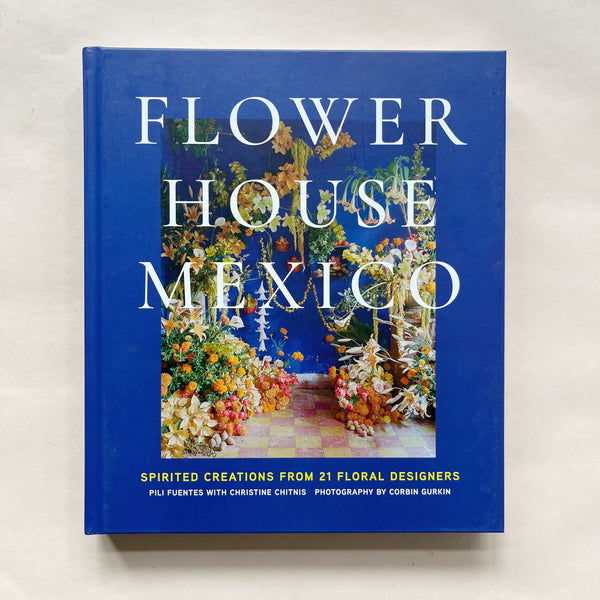 Book titled 'Flower House Mexico' with floral design images on a blue cover.