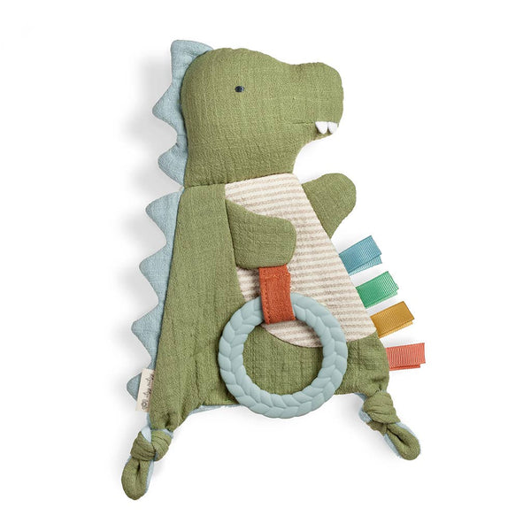 Green dinosaur-shaped crinkle toy with a teether ring on a white background