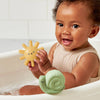 Baby playing with bath toys in a bathtub