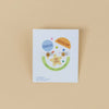 JaxKelly kid's earrings packaging on a beige background