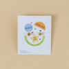 JaxKelly kid's earrings packaging on a beige background