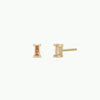 Gold stud earrings with champagne CZ gemstones on a white background