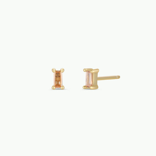 Gold stud earrings with champagne CZ gemstones on a white background