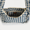 Interior shot of blue and white checkered bag with ruffled edges on a white background