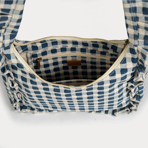 Interior shot of blue and white checkered bag with ruffled edges on a white background