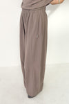 Brown wide-leg pants worn by a person on a white background