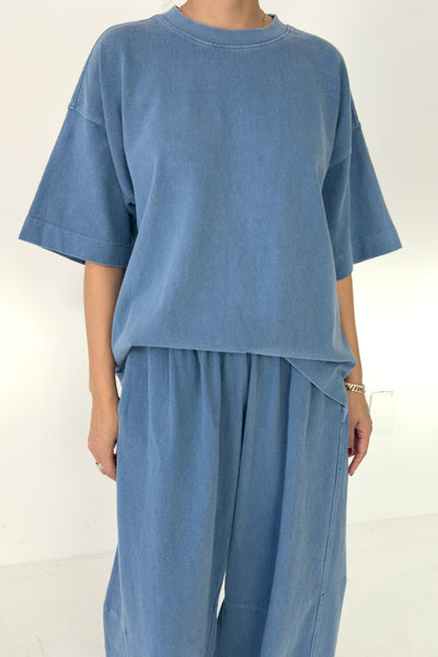 Person wearing a blue outfit on a white background