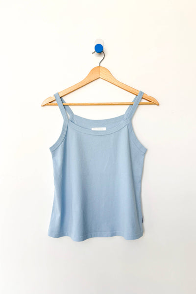 Light blue camisole tank top on a wooden hanger against a white background