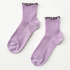 Pair of purple socks with brown ruffle trim on a white background