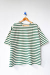 Green and white striped shirt on a hanger against a white background