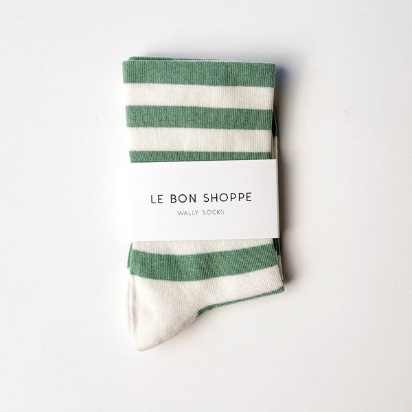 Green and white striped socks with 'Le Bon Shoppe' packaging on a white background
