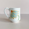 White ceramic mug with blue coneflower design.