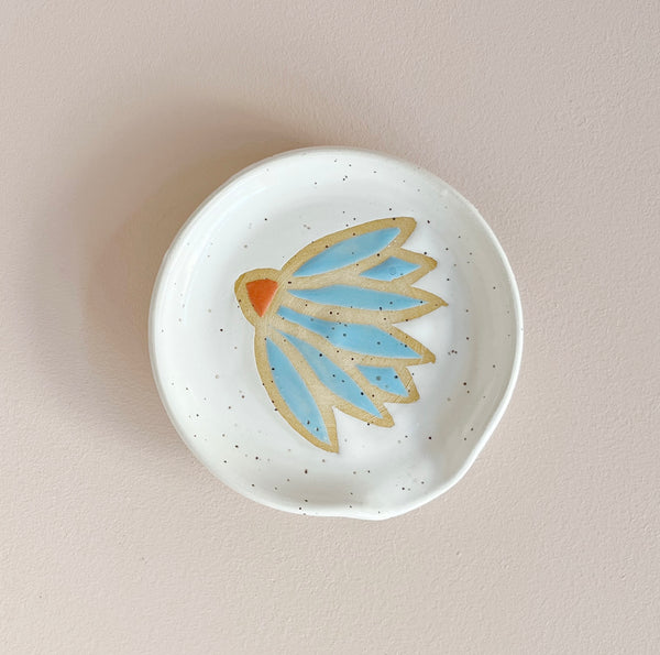 Ceramic spoon rest with blue coneflower design.