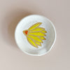 Ceramic spoon rest with yellow coneflower design.