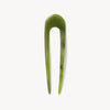 Algae green hair pin on a white background