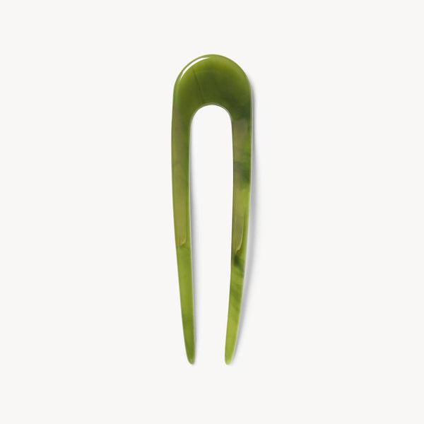 Algae green hair pin on a white background